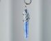 Natural blue kyanite pendant necklace with hand-soldered tin wire design, resembling ocean waves and glaciers.